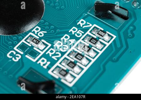 Macro shot of circuit board with resistors microchips and electronic components. Integrated communication processor. Information engineering. Stock Photo