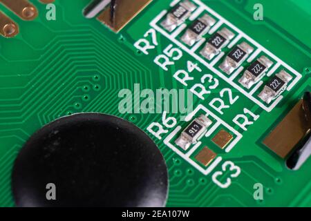 Macro shot of circuit board with resistors microchips and electronic components. Integrated communication processor. Information engineering. Stock Photo