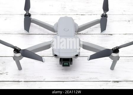 small drone copter on wooden white table. Close-up Stock Photo