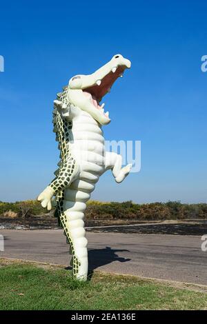 Funny jumping crocodile statue is a roadside attraction on the Arnhem Highway near Darwin, Northern Territory, NT, Australia Stock Photo