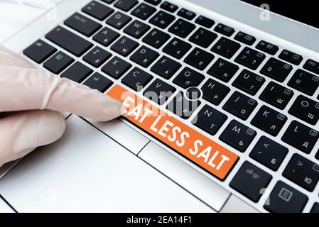 Handwriting text Eat Less Salt. Conceptual photo reducing the sodium intake on the food and beverages Different Colored PC keyboard key With Accessori Stock Photo