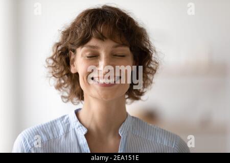 Overjoyed Caucasian woman close eyes make wish Stock Photo