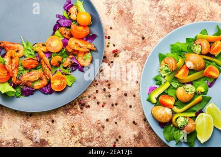 Tasty salad with shrimps,tomato and lettuce on a plate.Seafood prawn salad Stock Photo