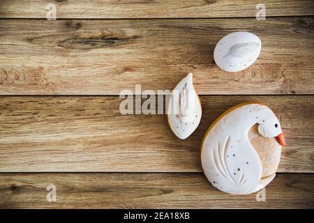 Sweets, pastry for Easter table. Easter eggs and handpainted gingerbread on wooden background. top view copy space Stock Photo
