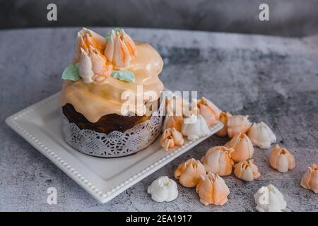 Easter Cake decorated with orange merengue - Traditional Kulich, Paska Easter Bread. Traditional Easter spring Stock Photo