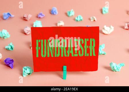 Text sign showing Fundraiser. Business photo showcasing an individual whose job or task is seek financial support for charity Colored crumpled rectang Stock Photo