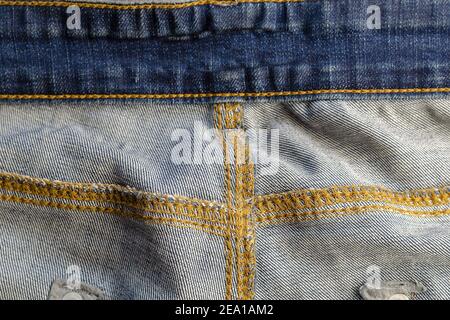 Wrong side of jeans fabric. Detailed shot of the back of the classic yellow threaded jeans. Copy space Stock Photo