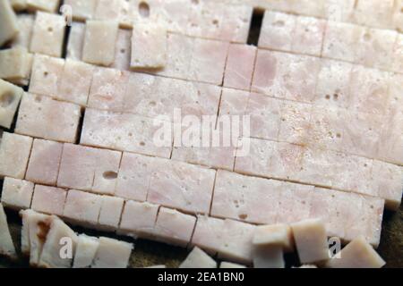 Preparing food items for cooking: chopped sliced turkey pieces in a closeup. Healthy low fat meat to be used for an omelette. Home cooking. Stock Photo