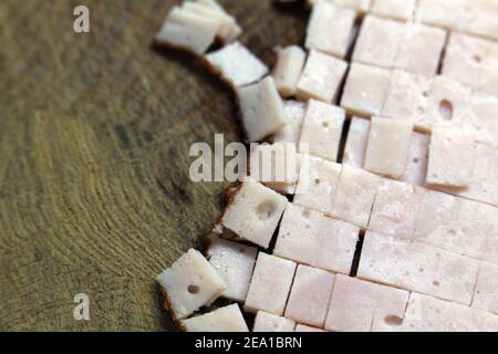 Preparing food items for cooking: chopped sliced turkey pieces in a closeup. Healthy low fat meat to be used for an omelette. Home cooking. Stock Photo