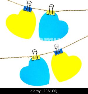 two hearts yellow and blue hanging on a rope with trailers Stock Photo