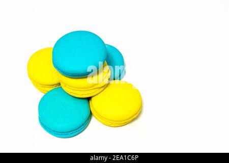 yellow and blue macaroni cookies stacked in a stack on an isolated background Stock Photo