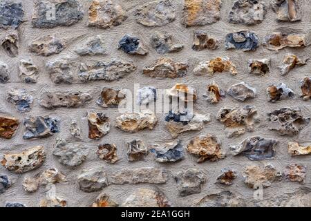 Background of cement wall with bricks in yellow, grey and blue Stock Photo