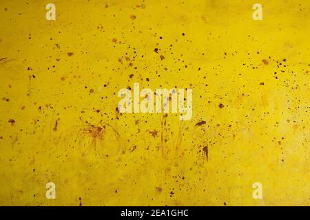 Yellow colored wall with abstract red soil mud splashes and stain on it. Stock Photo