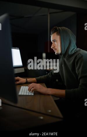 Cyber criminal hacking system at monitors, hacker hands at work ...