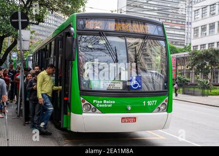 Passengers climbing aboard a local bus in Sao Paulo, Brazil. Stock Photo