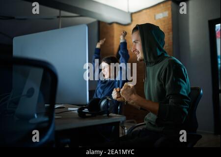 Male and female hackers works in darknet Stock Photo