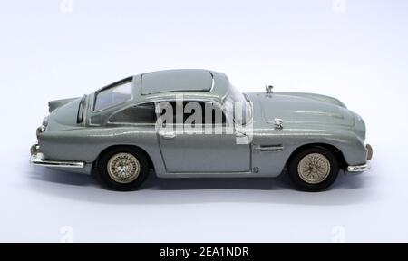 Photo of a Silver die cast model of the Aston Martin DB5 famously used in the Sean Connery James Bond 007 movie Goldfinger in 1964 side view Stock Photo