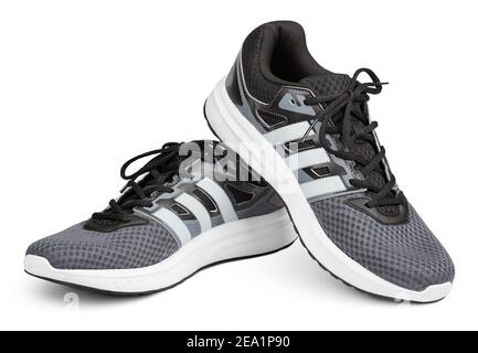 Pair of new unbranded gray sport running shoes, sneakers or trainers isolated on white background with clipping path Stock Photo