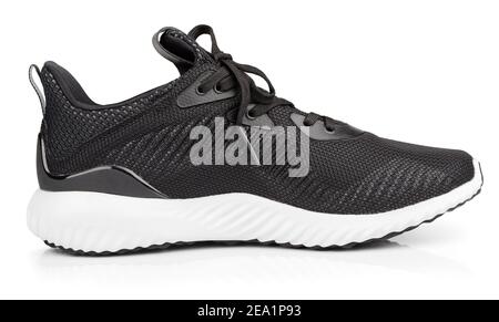Single new unbranded black sport running shoe, sneakers or trainers isolated on white background with clipping path Stock Photo