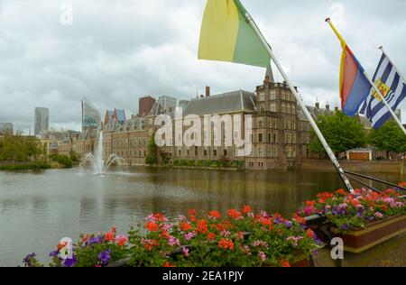 The Binnenhof castle on a cloudy day, next to the Hofvijver lake in the city center of The Hague (Den Haag). The Dutch parliament building is located