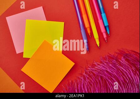 Pens and notepads closeup, red background Stock Photo