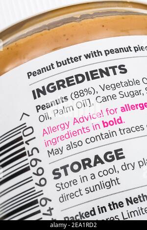 Plastic tub of ASDA own-label peanut butter. For food ingredients labels, nutrition labelling, food facts, peanut allergy advice, plastic packaging. Stock Photo