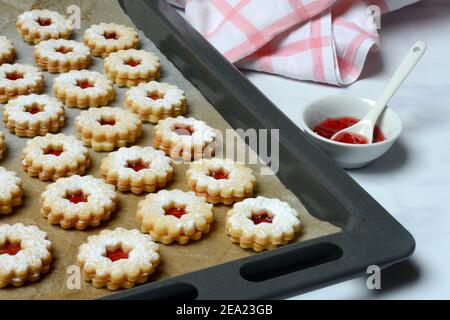 Spitzbube, cookies on baking tray and tray with jelly, Germany Stock Photo