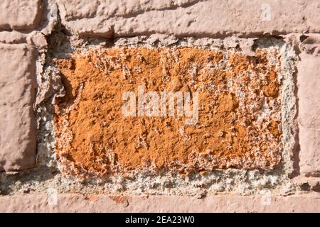 Close-up old red brick wall c. Texture. The bricks are covered with paint that has partially peeled of Stock Photo