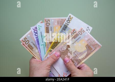 The hands close-up of a man are holding euro banknotes Stock Photo