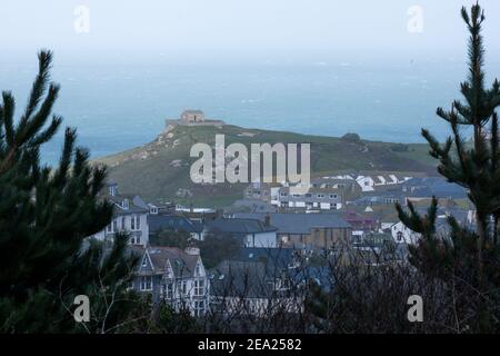 View down from the hill above of St. Ives town showing houses, unique church and bay beyond. Very quiet due to the lockdown caused by the pandemic Stock Photo