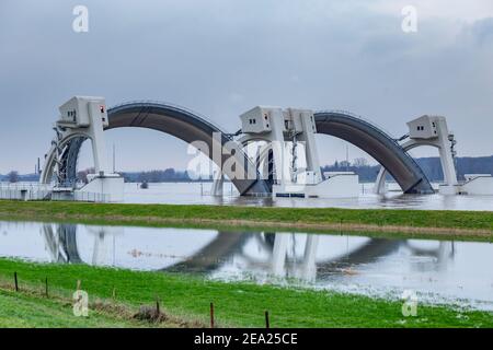 Driel, The Netherlands - February 5, 2021: Weir Driel in the river Rhine with open bows during high water Stock Photo