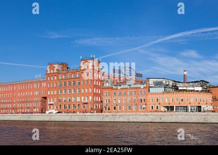 MOSCOW, RUSSIA -SEPTEMBER 21, 2015:  Famous Russian chocolate factory Red October in the summer against the blue sky at sunset. Red brick building. Vi Stock Photo