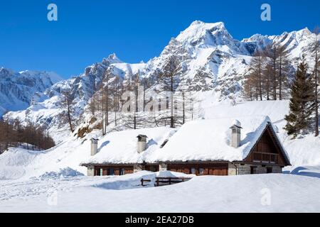 View of mountain huts in the small town of Crampiolo in winter. Alpe Devero, Antigorio valley, Piedmont, Italy.