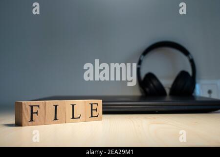 Word File. Computer and headphones concept on the background. Studio Stock Photo