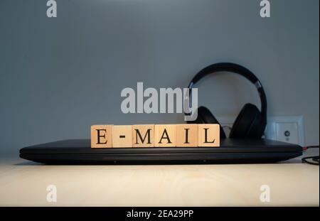 email word written on the background computer and headset concept. Closeup. Stock Photo