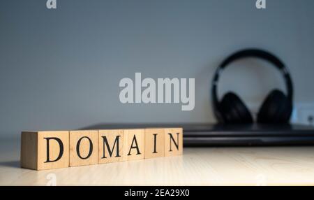 The word domain is written. computer and headset concept on the background. Stock Photo