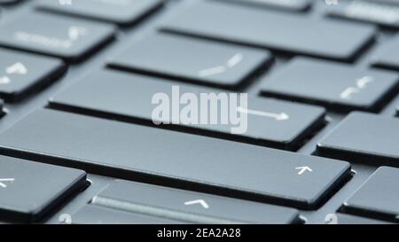 Gray laptop keyboard macro  close-up. Selective focus on enter buttons. Stock Photo