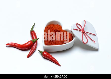 Chili powder in bowl with heart shape, chili peppers( Capsicum annuum) , I love chili Stock Photo
