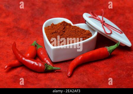 Chili powder in bowl with heart shape, chili peppers( Capsicum annuum) , I love chili Stock Photo