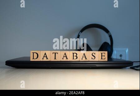 DATABASE message word on a wooden desk on cube blocks. Close up Stock Photo