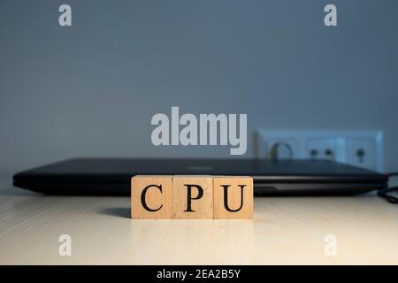 The word CPU is written. Computer and headset in the background. Closeup. Stock Photo