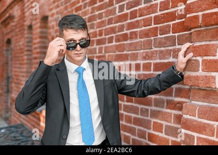 Gaze through the glasses of a young man in a formal suit. The concept of bullying and angry emotions Stock Photo