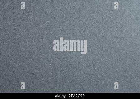 The texture is grainy. Macro photo of a smooth gray plastic surface Stock Photo