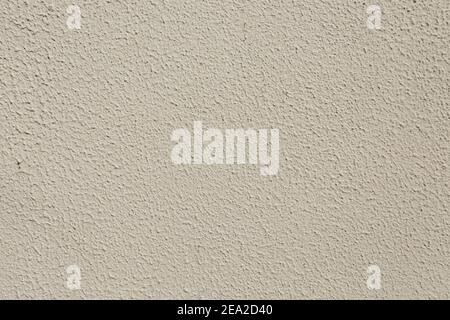 Beige wall close-up. Granular texture Stock Photo