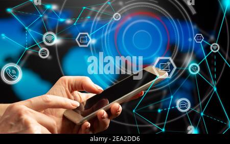 Global communications concept. Close-up hands with smartphone. Double exposure - icons, connections and schematic representation of the global communi Stock Photo