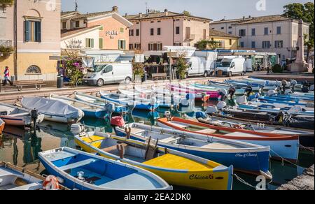 Bardolino on Garda lake in northern Italy. Fishing Boats in the old harbour. Bardolino, Verona province, Italy - october 29, 2020 Stock Photo