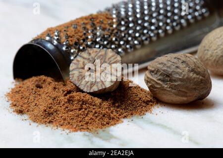 Nutmegs and nutmeg powder with grater, ground, nutmeg grater ( Myristica fragrans) Stock Photo