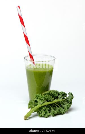 Kale smoothie in glass with drinking straw, smoothie, kale, curly kale, kale with feathers, winter kale ( Brassica oleracea) acephala var. sabellica Stock Photo