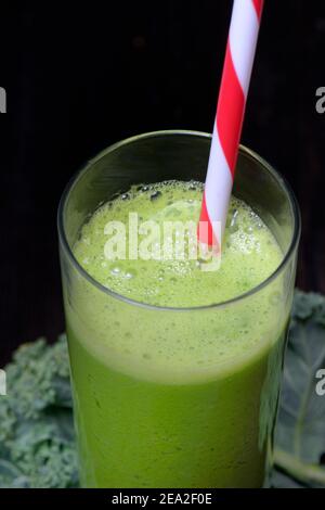 Kale smoothie in glass with drinking straw, smoothie, kale, curly kale, kale with feathers, winter kale ( Brassica oleracea) acephala var. sabellica Stock Photo