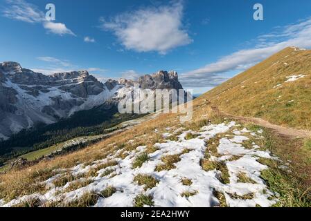 Trail on autumn landscape at Medalgesalm alp in front of  in the rocky Puez-Odle mountains in the morning sun, Dolomites, South Tyrol, Italy